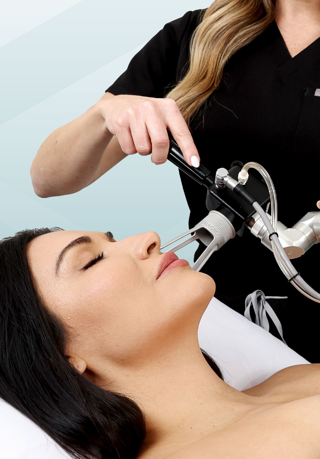 Woman lying with eyes closed during a cosmetic facial procedure using a handheld device.